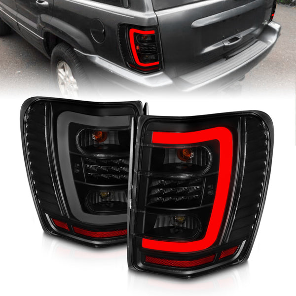 ANZO 1999-2004 Jeep Grand Cherokee LED Tail Lights w/ Light Bar Black Housing Smoke Lens - Premium Tail Lights from ANZO - Just 1439.45 SR! Shop now at Motors